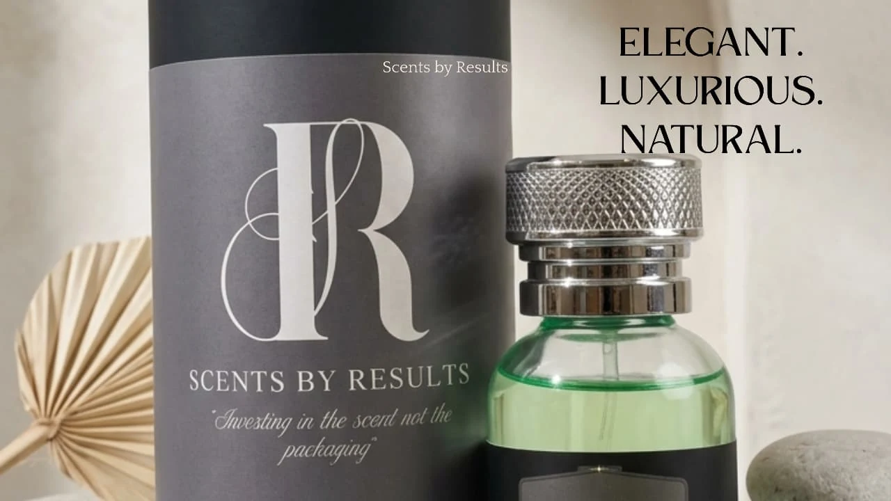 Elegant. Luxurious. Natural. A close view of the charcoal Scents by Results tube beside Mulaqat's green bottle and knurled silver cap, with a dried palm leaf and a pale stone.